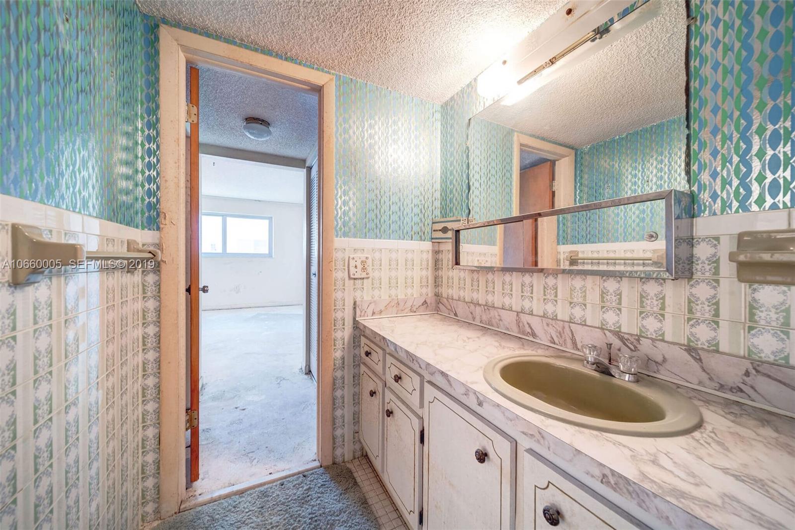 1674 Bay Road, Unit 403 Miami Beach, FL 33139 - Photo 15 of 23 a bathroom with a sink and a mirror