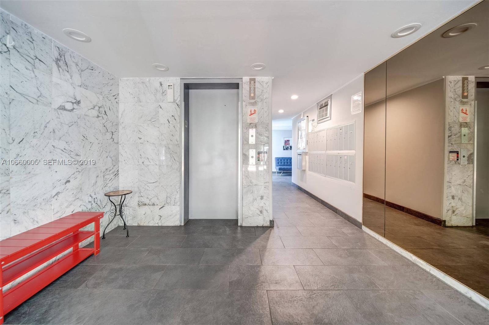 1674 Bay Road, Unit 403 Miami Beach, FL 33139 - Photo 18 of 23 a view of a hallway with seating area