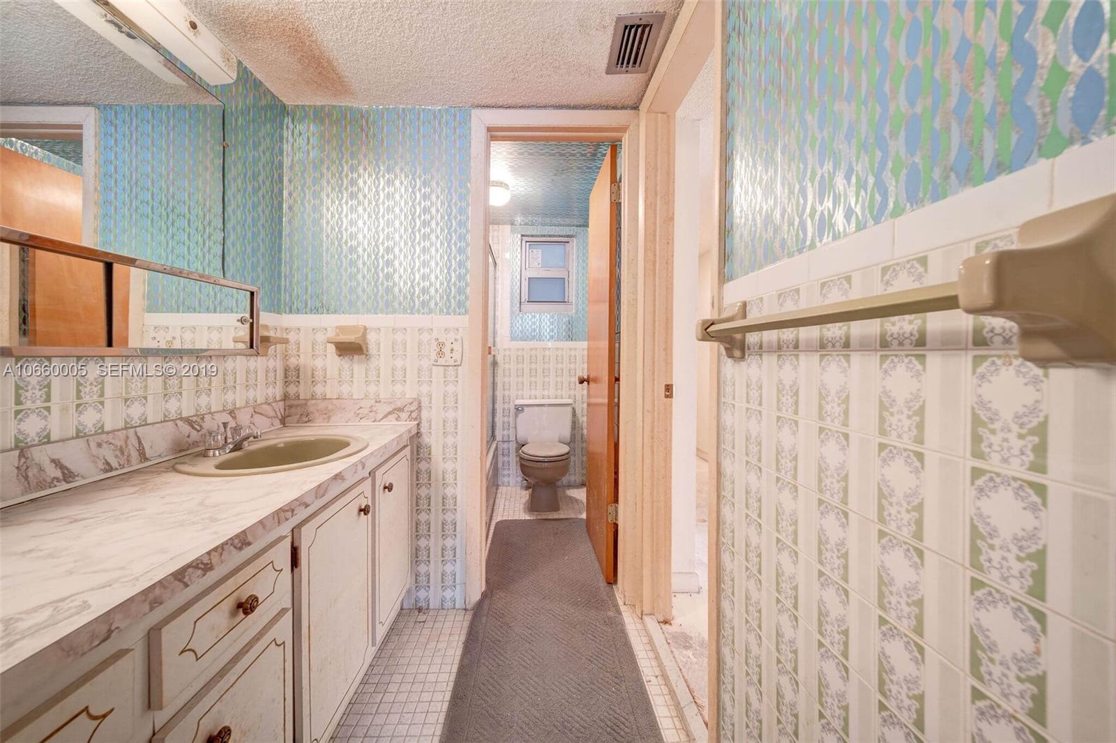 1674 Bay Road, Unit 403 Miami Beach, FL 33139 - Photo 23 of 23 a bathroom with a sink a toilet and shower
