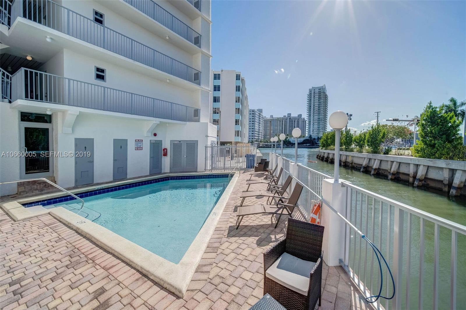 1674 Bay Road, Unit 403 Miami Beach, FL 33139 - Photo 4 of 23 a view of a balcony with a floor to ceiling window and wooden fence
