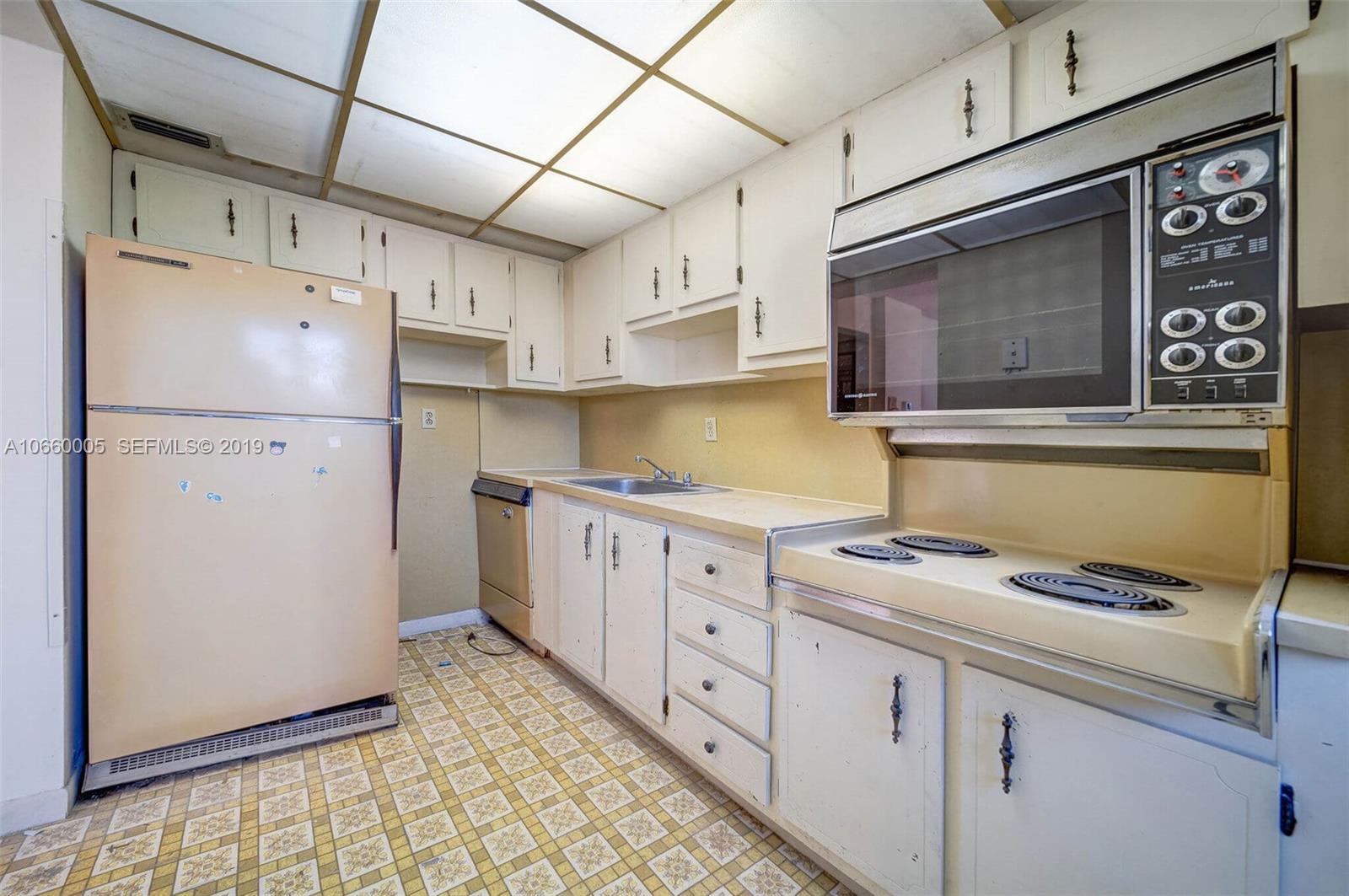 1674 Bay Road, Unit 403 Miami Beach, FL 33139 - Photo 7 of 23 a kitchen with granite countertop cabinets stainless steel appliances and a counter space