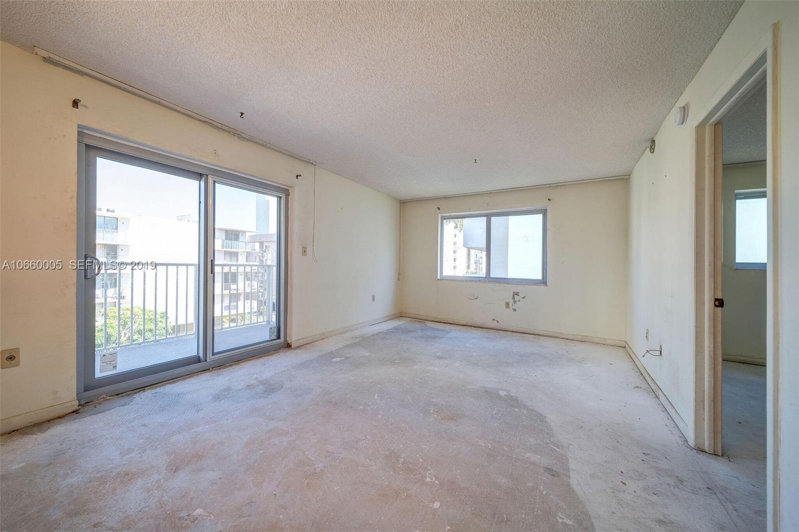 1674 Bay Road, Unit 403 Miami Beach, FL 33139 - Photo 8 of 23 a view of an empty room with windows