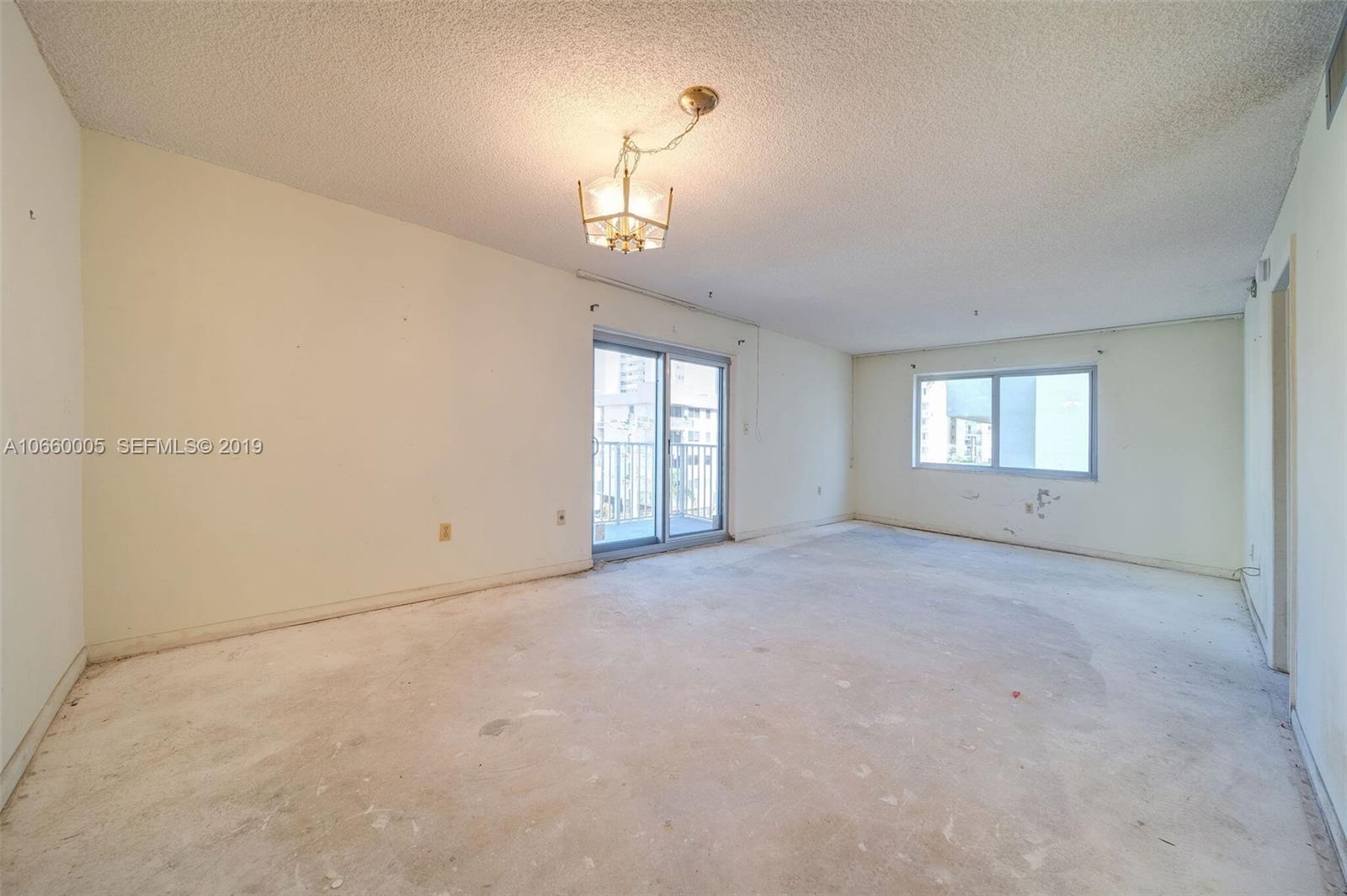 1674 Bay Road, Unit 403 Miami Beach, FL 33139 - Photo 10 of 23 an empty room with windows and entrance