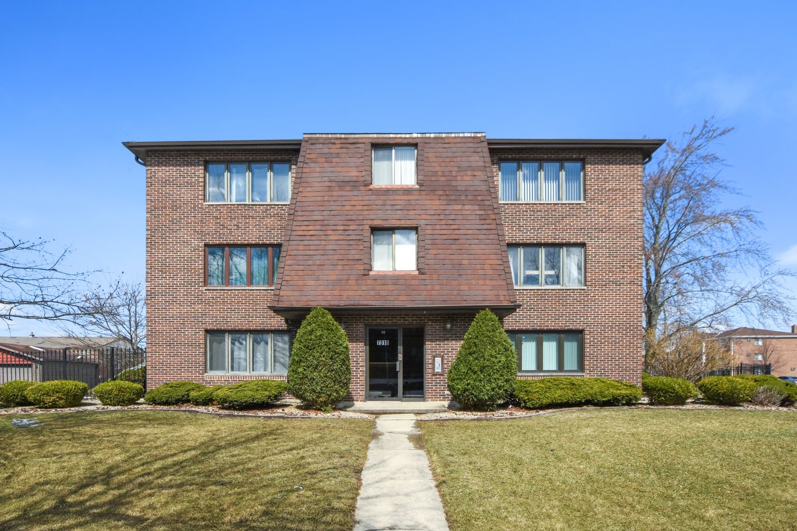 7310 Tiffany Drive, Unit 2B Orland Park, IL 60462 - Photo 1 of 1 a front view of a house with a yard