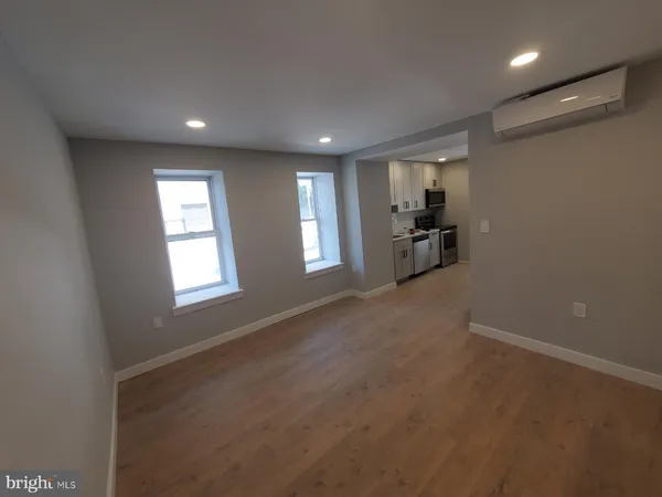 an empty room with a fireplace and windows