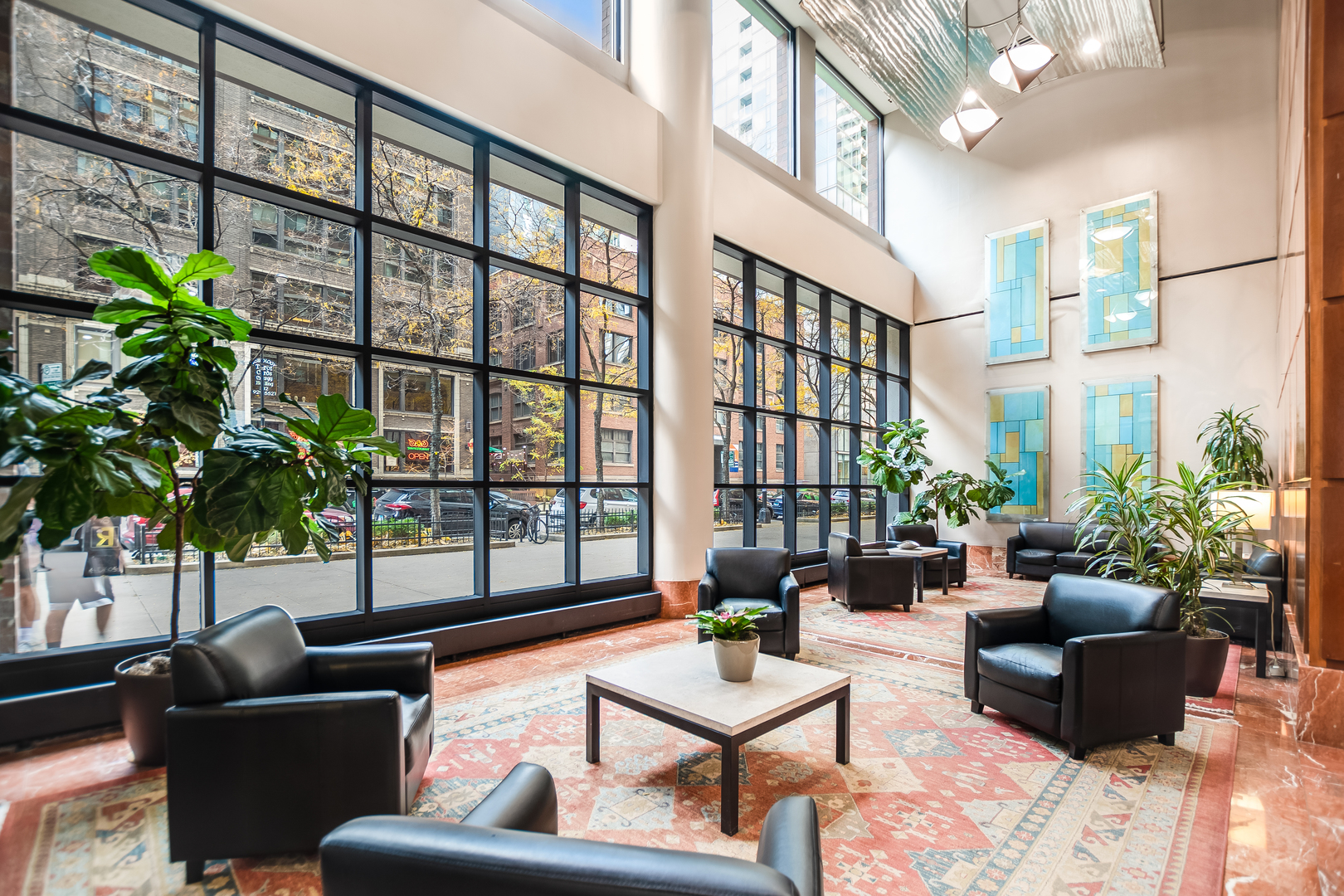 211 East Ohio Street, Unit 609 Chicago, IL 60611 - Photo 9 of 19 a living room filled with furniture and a potted plant