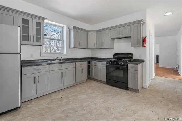 a kitchen with a stove sink and cabinets