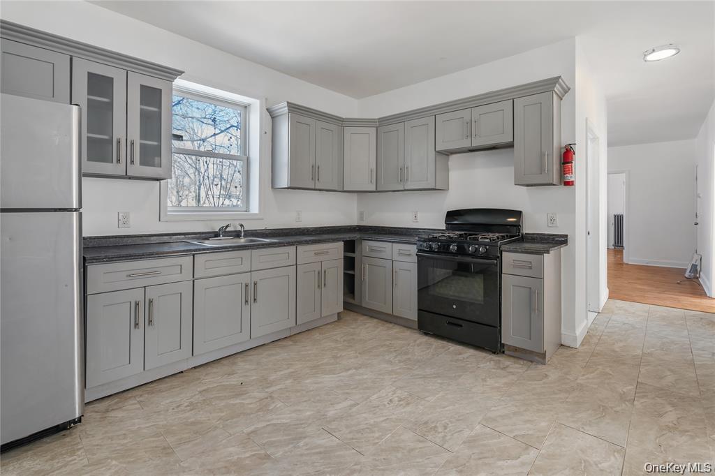94 Winnikee Avenue, Unit 3 Poughkeepsie, NY 12601 - Photo 2 of 12 a kitchen with a stove sink and cabinets