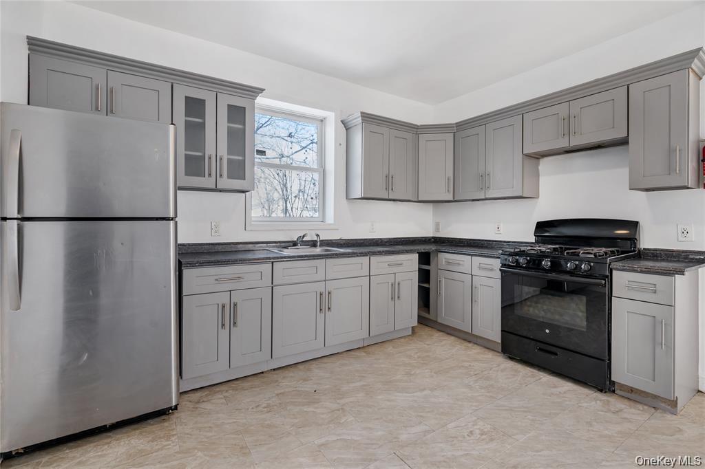 94 Winnikee Avenue, Unit 3 Poughkeepsie, NY 12601 - Photo 4 of 12 a kitchen with a refrigerator stove and sink