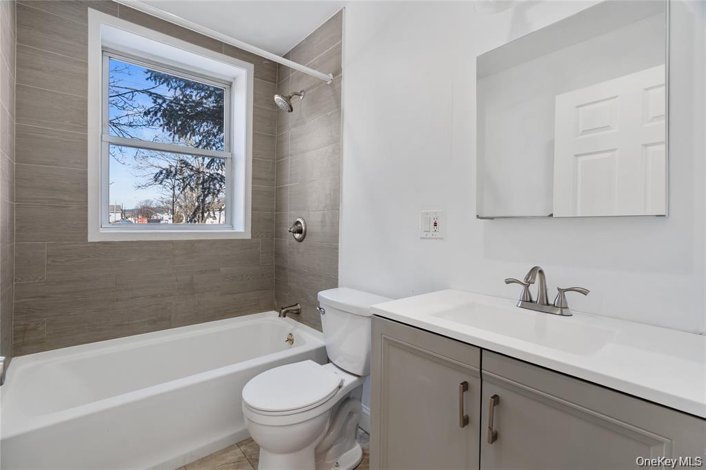94 Winnikee Avenue, Unit 3 Poughkeepsie, NY 12601 - Photo 10 of 12 a bathroom with a sink a toilet and a bathtub