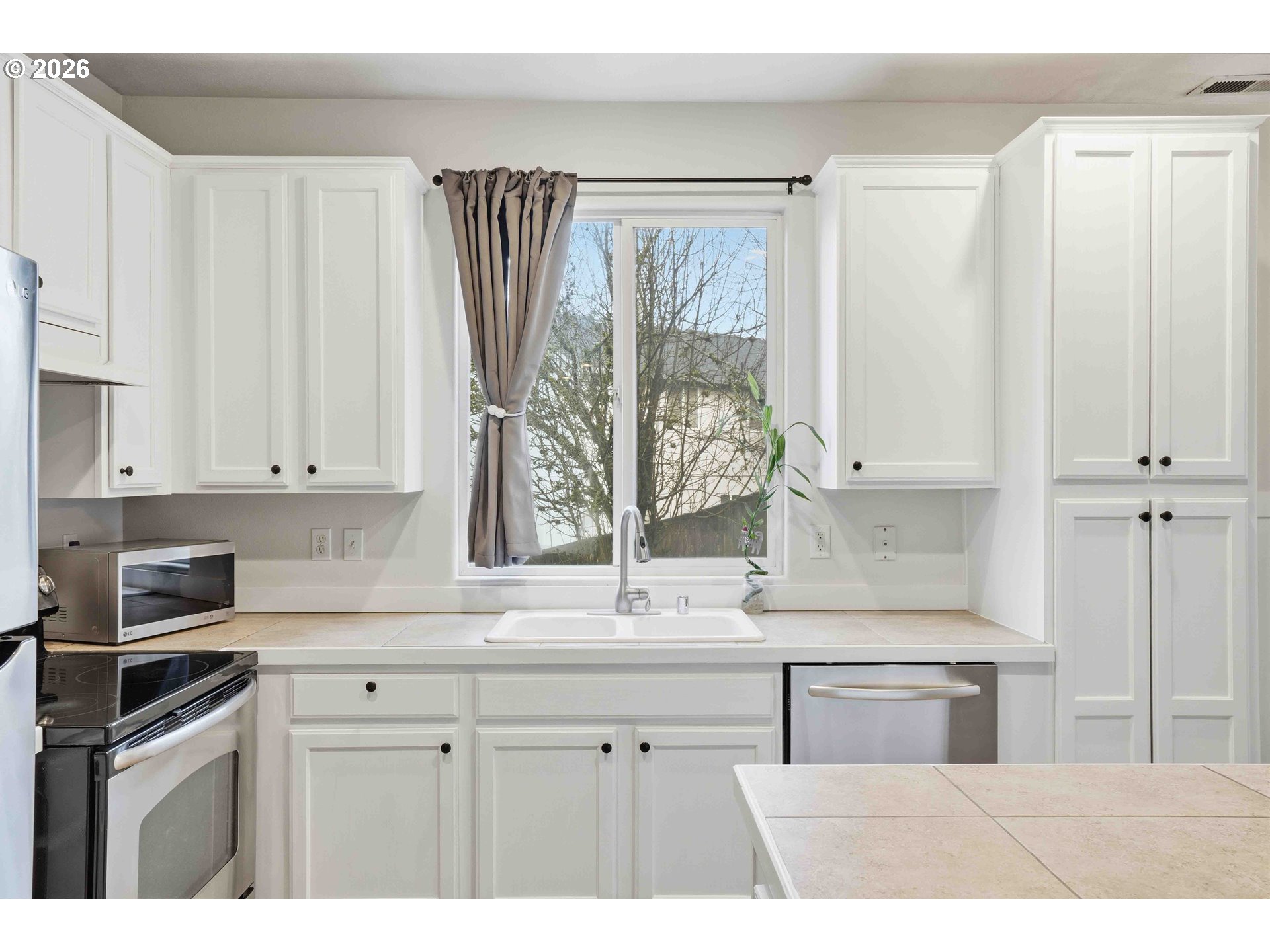 3323 Northwest 31st Circle Camas, WA 98607 - Photo 12 of 25 a kitchen with a sink cabinets and a window