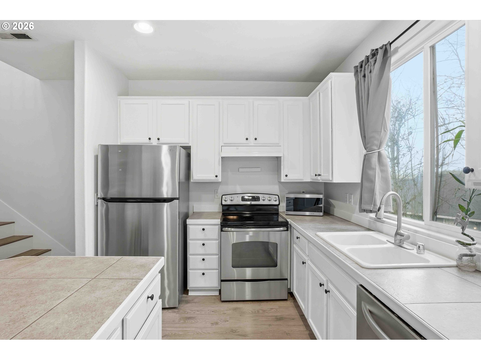 3323 Northwest 31st Circle Camas, WA 98607 - Photo 13 of 25 a kitchen with a sink a refrigerator a washer and dryer