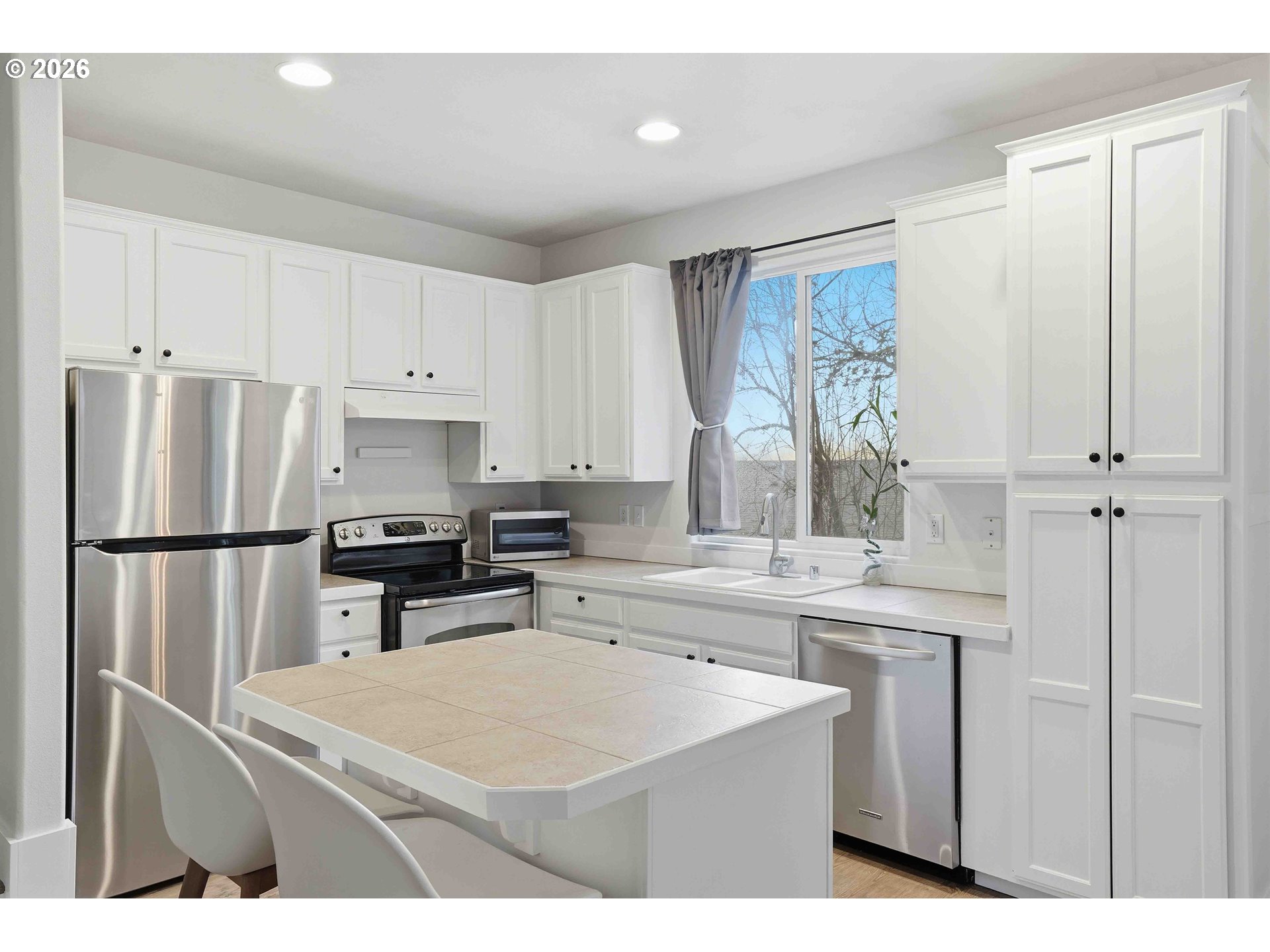 3323 Northwest 31st Circle Camas, WA 98607 - Photo 10 of 25 a kitchen with stainless steel appliances a refrigerator sink and cabinets