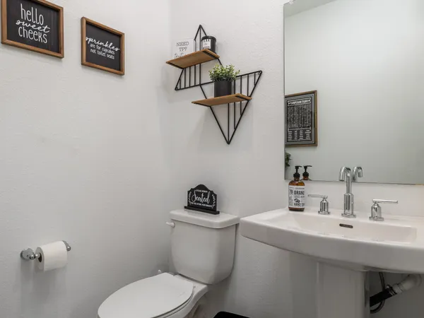 a bathroom with a toilet a sink and mirror