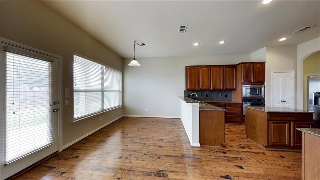 7136 Playa Grand Prairie, TX 75054 - Photo 18 of 36 a kitchen with stainless steel appliances granite countertop a refrigerator and a stove top oven