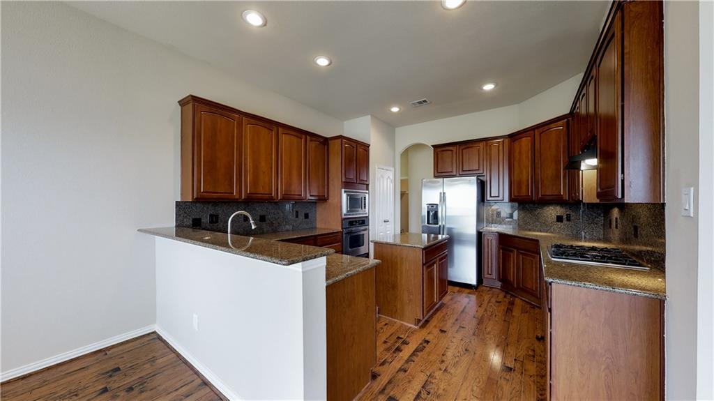 7136 Playa Grand Prairie, TX 75054 - Photo 19 of 36 a kitchen with stainless steel appliances granite countertop a refrigerator stove a sink and dishwasher