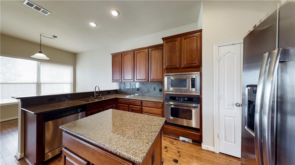 7136 Playa Grand Prairie, TX 75054 - Photo 23 of 36 a kitchen with granite countertop a refrigerator stove and sink