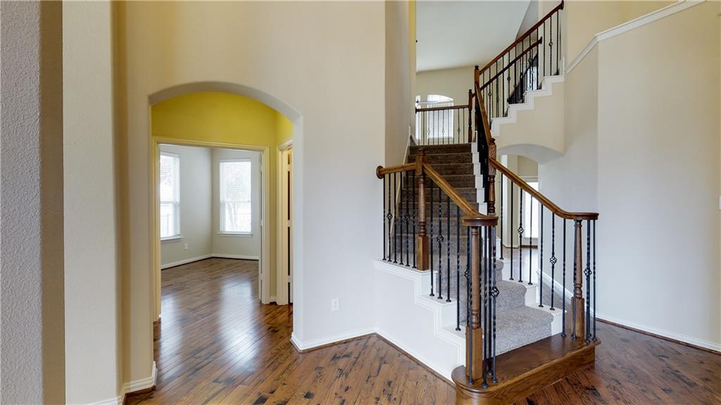 7136 Playa Grand Prairie, TX 75054 - Photo 9 of 36 a view of a hallway with wooden floor and staircase