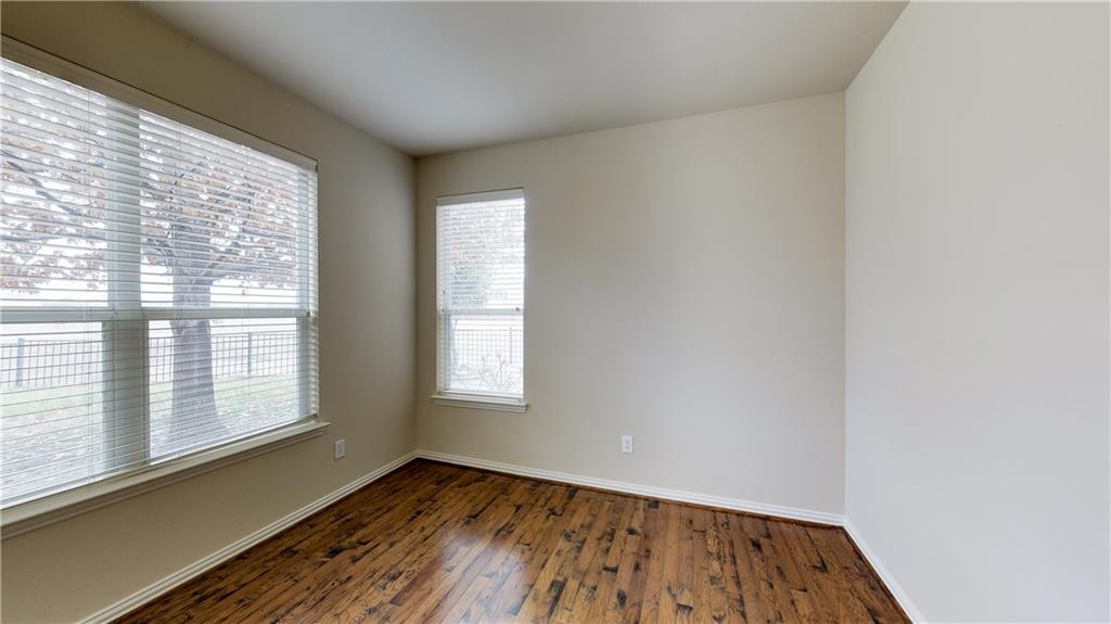 7136 Playa Grand Prairie, TX 75054 - Photo 10 of 36 a view of an empty room with wooden floor and a window