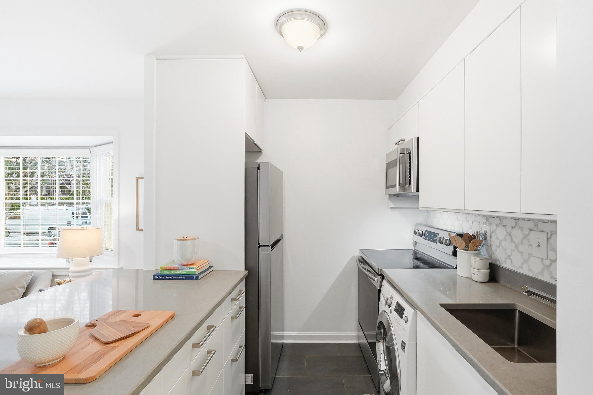 1833-1855 Biltmore Street Northwest, Unit A Washington, DC 20009 - Photo 11 of 22 a kitchen that has a sink and a stove in it