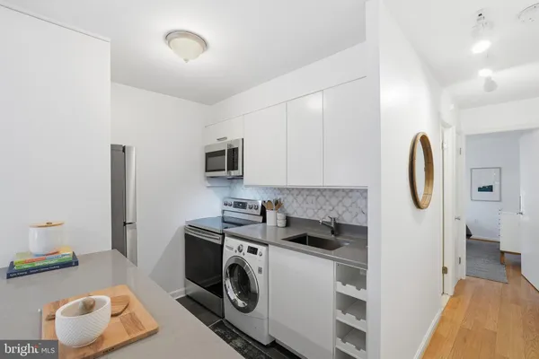 a kitchen with stainless steel appliances a microwave a stove and a refrigerator