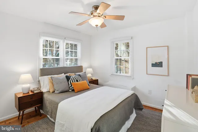 a bedroom with a bed and a lamp on table