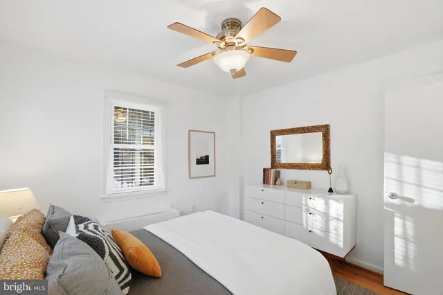 a bedroom with a bed dresser and a window