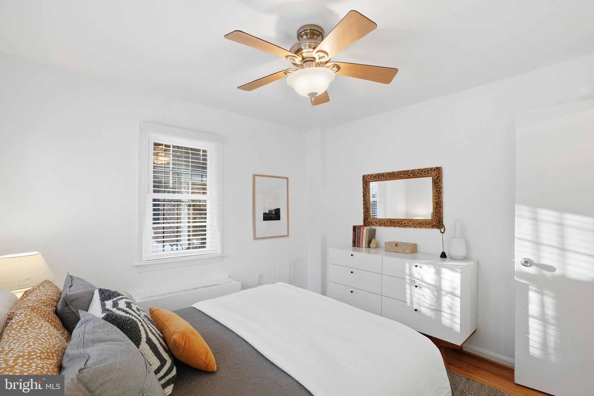 1833-1855 Biltmore Street Northwest, Unit A Washington, DC 20009 - Photo 15 of 22 a bedroom with a bed dresser and a window