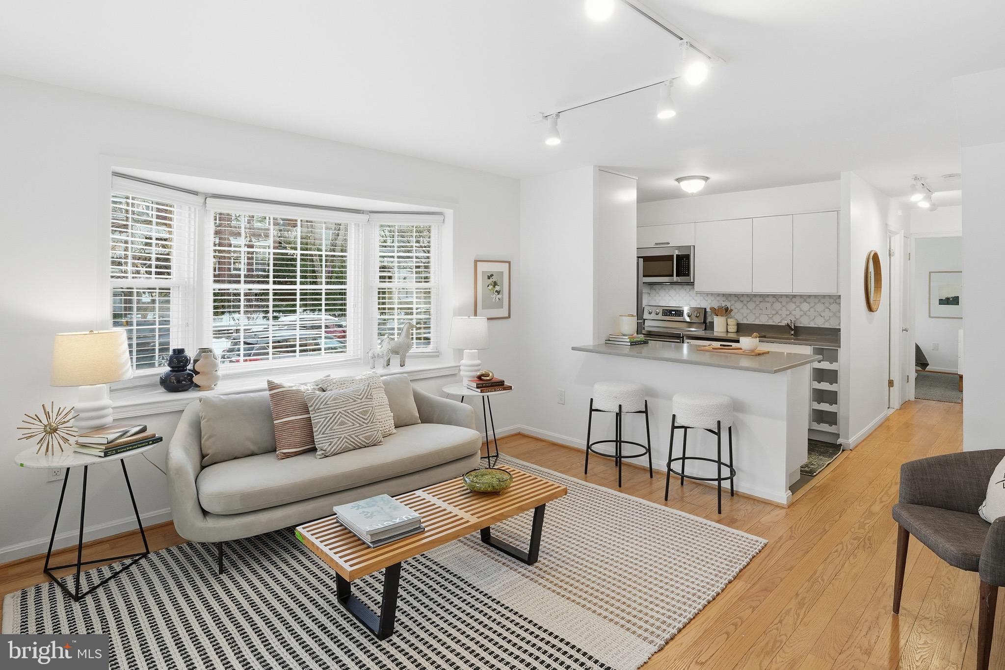 1833-1855 Biltmore Street Northwest, Unit A Washington, DC 20009 - Photo 3 of 22 a living room with furniture and a large window