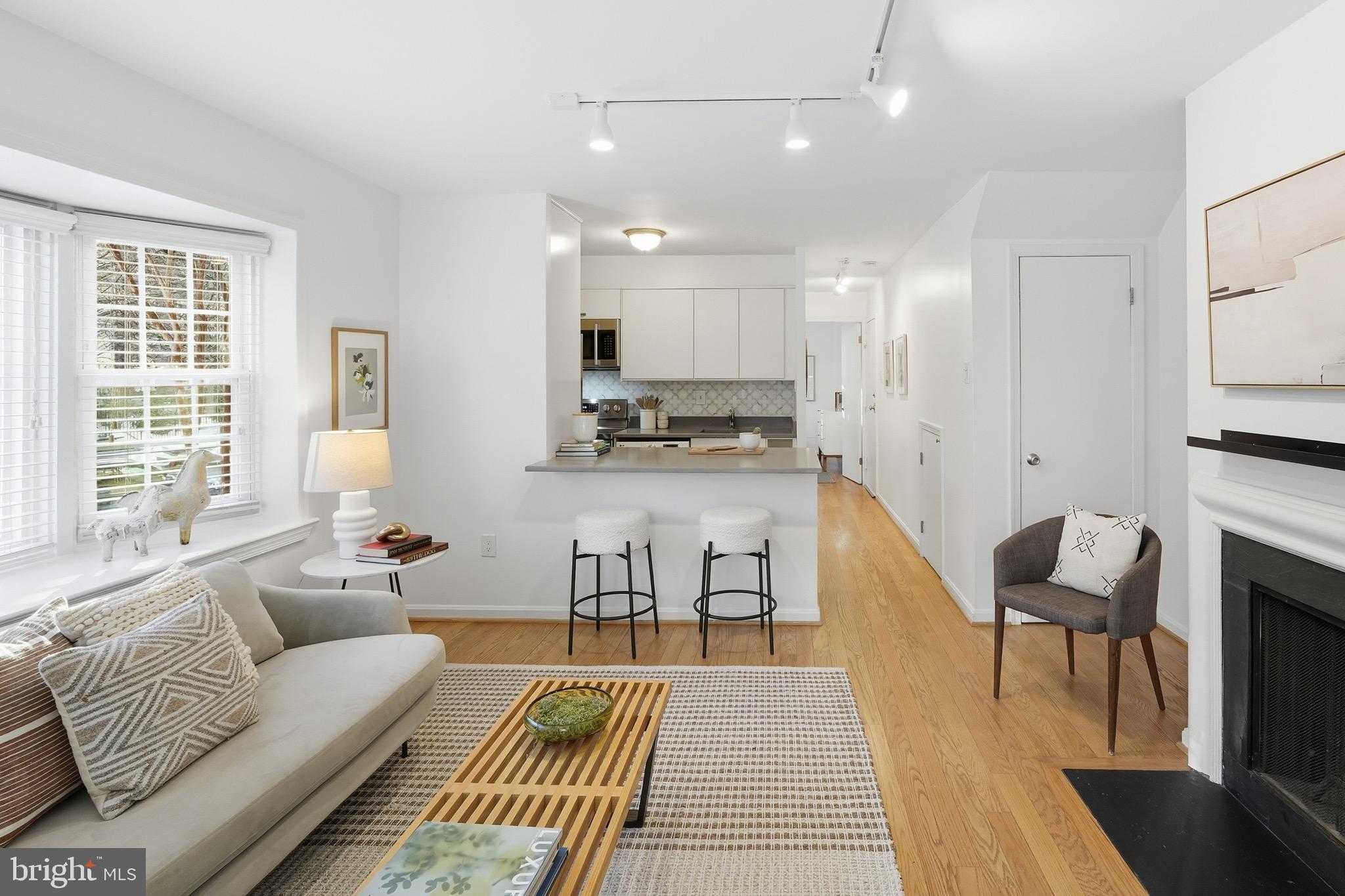 1833-1855 Biltmore Street Northwest, Unit A Washington, DC 20009 - Photo 9 of 22 a living room with furniture and a wooden floor