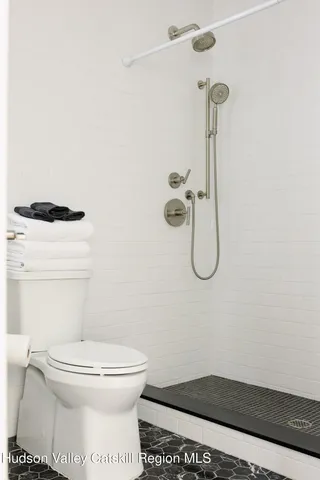 a bedroom with a bed and a night stand