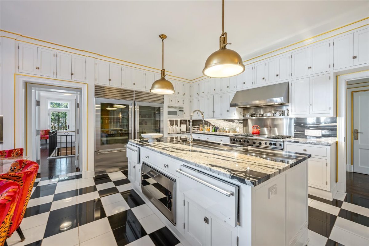 919 Hill Road Winnetka, IL 60093 - Photo 12 of 57 a kitchen with stainless steel appliances granite countertop a sink a stove and a refrigerator