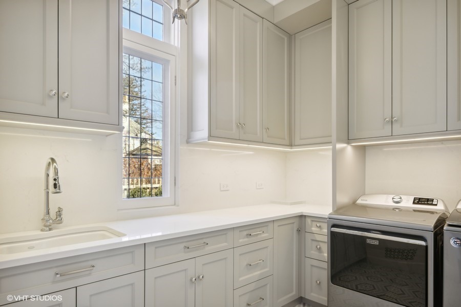 919 Hill Road Winnetka, IL 60093 - Photo 20 of 57 a kitchen with stainless steel appliances granite countertop white cabinets and a window