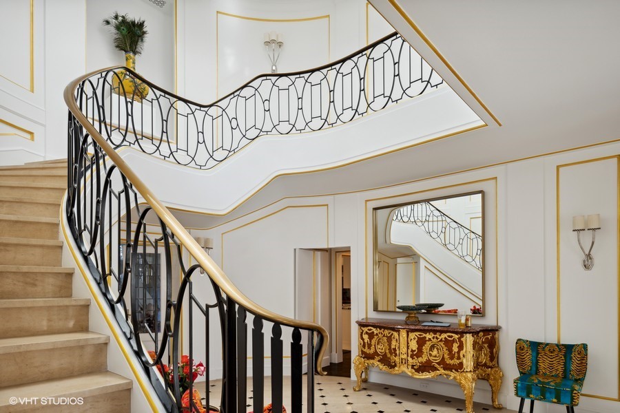 919 Hill Road Winnetka, IL 60093 - Photo 21 of 57 a view of staircase with lots of frames on wall and wooden floor