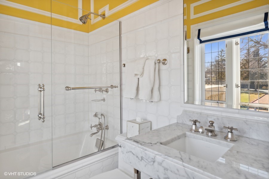 919 Hill Road Winnetka, IL 60093 - Photo 32 of 57 a bathroom with a granite countertop sink a shower and a mirror