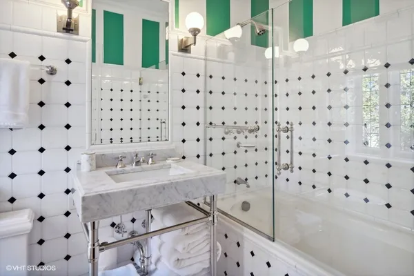 a kitchen with stainless steel appliances granite countertop a sink a stove and a refrigerator