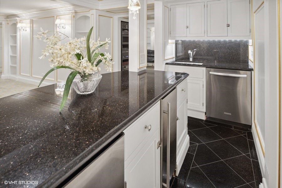 919 Hill Road Winnetka, IL 60093 - Photo 39 of 57 a kitchen with stainless steel appliances granite countertop a sink a stove and a refrigerator