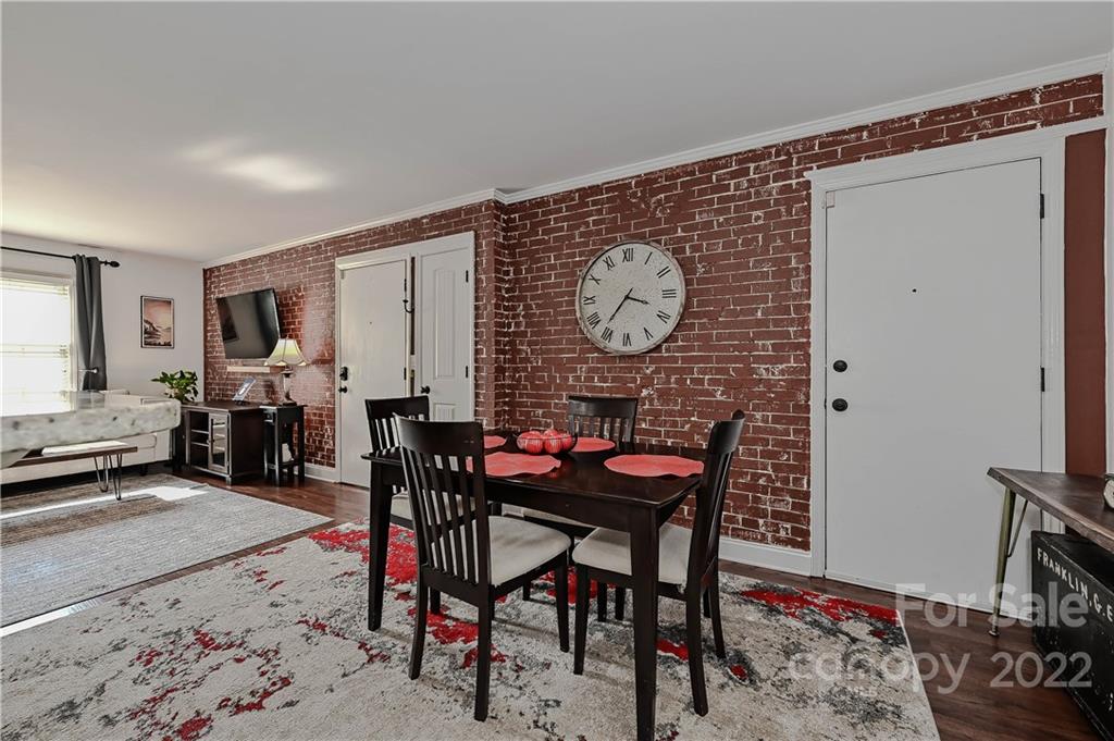4919 Park Road, Unit D Charlotte, NC 28209 - Photo 12 of 27 a living room with furniture a clock on wall and a window