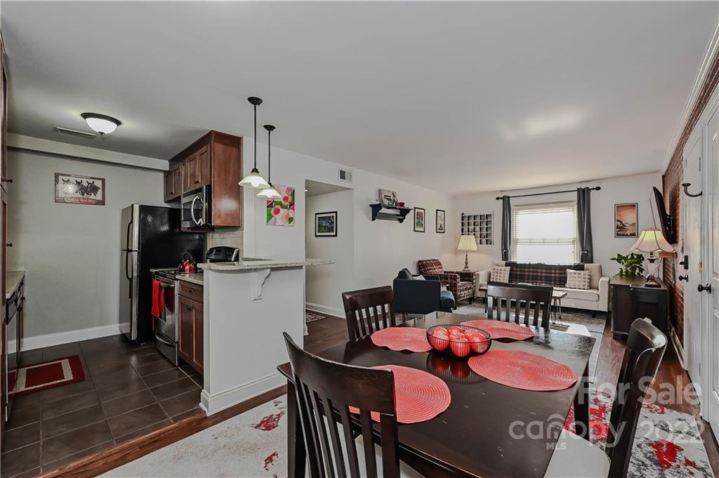 4919 Park Road, Unit D Charlotte, NC 28209 - Photo 13 of 27 a dining room with furniture and wooden floor