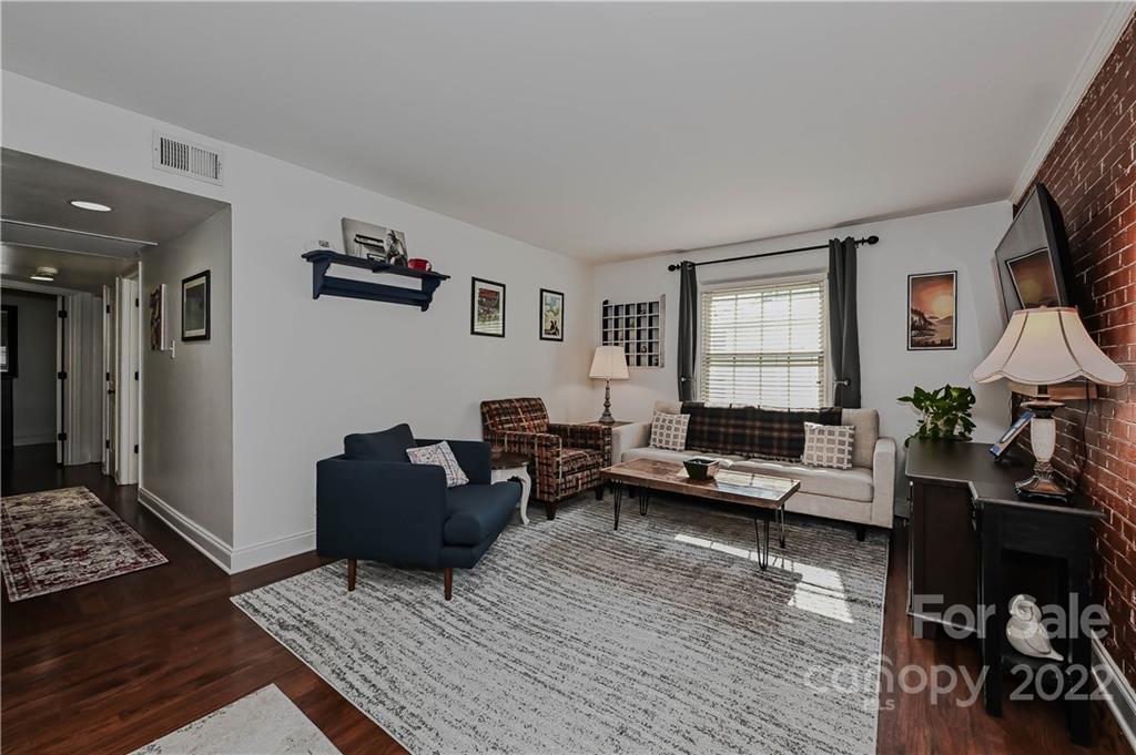 4919 Park Road, Unit D Charlotte, NC 28209 - Photo 15 of 27 a living room with furniture and a wooden floor