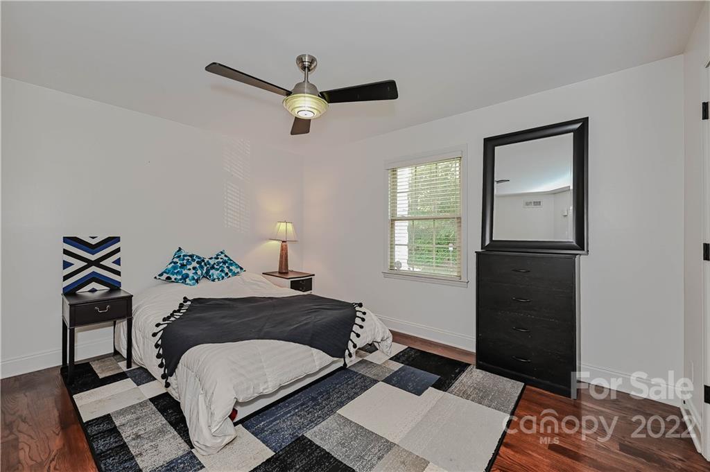 4919 Park Road, Unit D Charlotte, NC 28209 - Photo 16 of 27 a bedroom with a bed and wooden floor