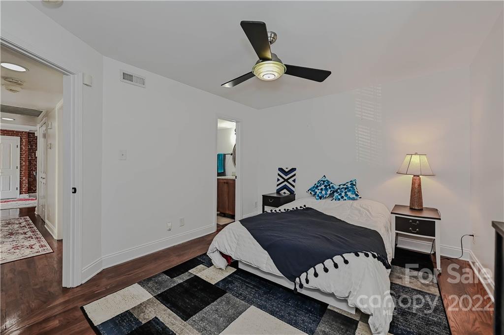 4919 Park Road, Unit D Charlotte, NC 28209 - Photo 17 of 27 a bedroom with a bed window and a table