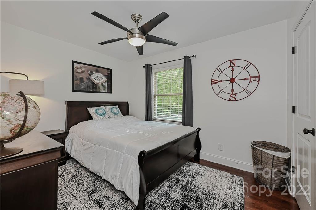 4919 Park Road, Unit D Charlotte, NC 28209 - Photo 20 of 27 a bedroom with a bed and a wall painting