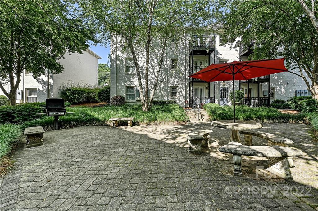 4919 Park Road, Unit D Charlotte, NC 28209 - Photo 25 of 27 a view of backyard with outdoor seating and trees
