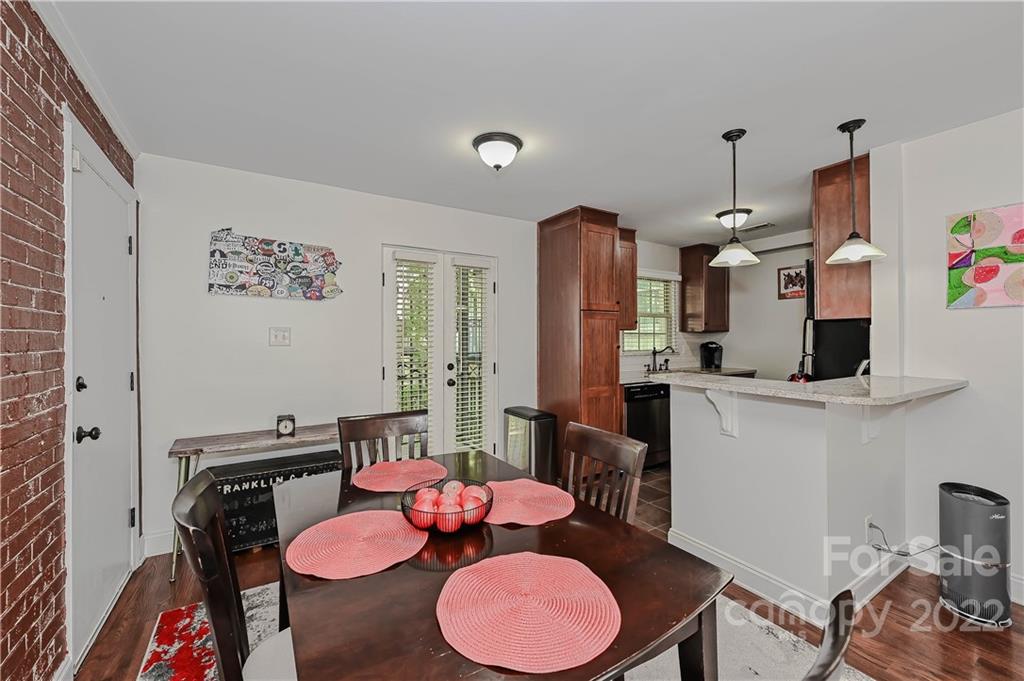 4919 Park Road, Unit D Charlotte, NC 28209 - Photo 7 of 27 a dining room with furniture and wooden floor