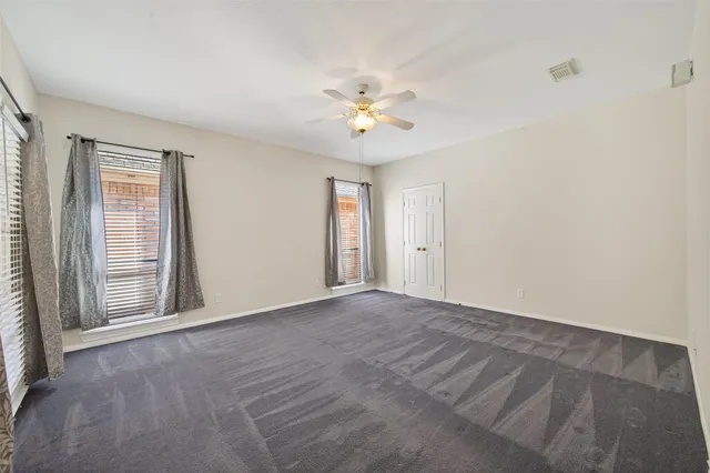 a bathroom with a granite countertop sink a toilet and a bathtub
