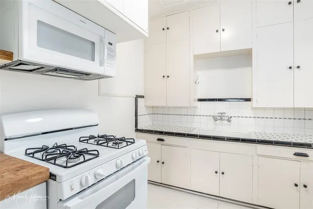 a kitchen with a refrigerator and a window