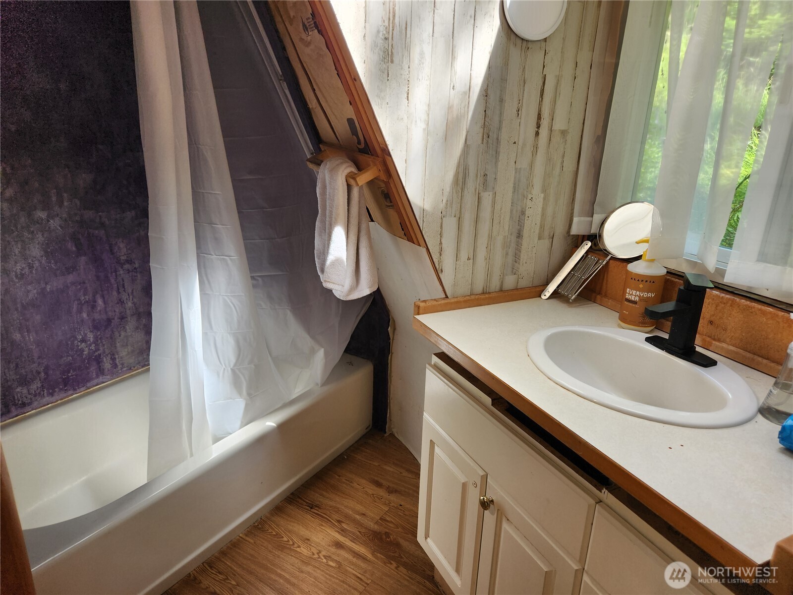 3226 Kelly Road Bellingham, WA 98226 - Photo 11 of 40 a bathroom with a sink a mirror and a shower