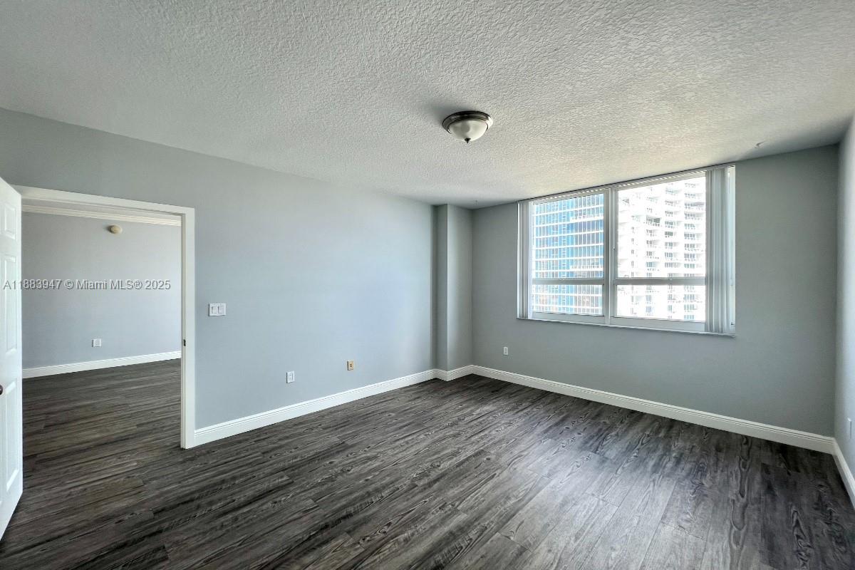 2000 North Bayshore Drive, Unit 1105 Miami, FL 33137 - Photo 16 of 29 a view of an empty room with wooden floor and a window