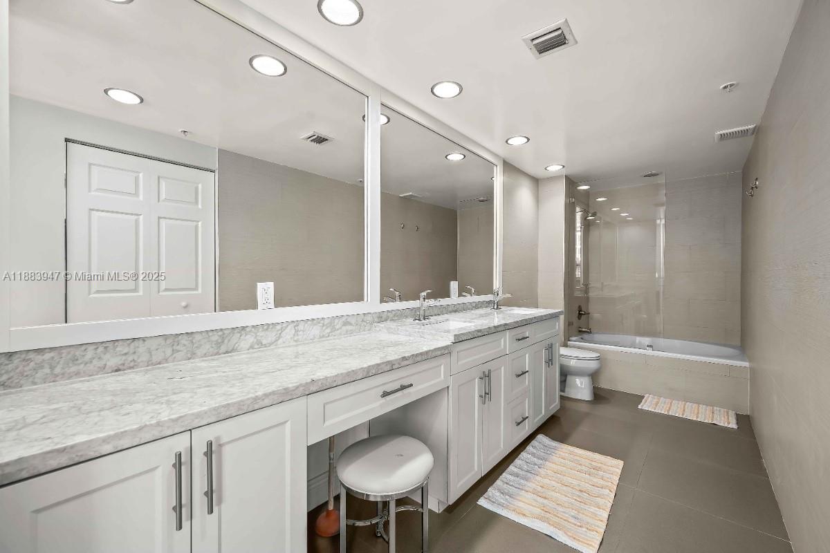 2000 North Bayshore Drive, Unit 1105 Miami, FL 33137 - Photo 17 of 29 a bathroom with a granite countertop double vanity sink and a mirror